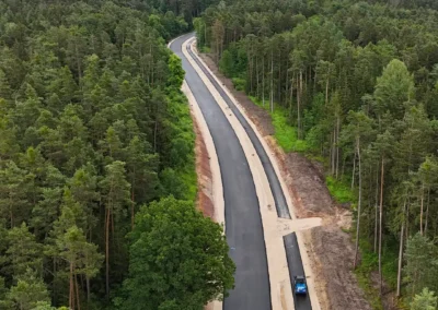 Eine neue Straße durchschneidet den Wald bei Reckenstetten, ein Baufahrzeug ist zu sehen.